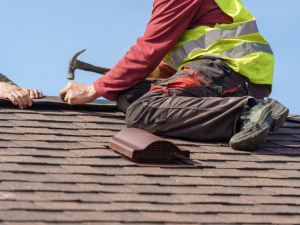 Roof repair team fixing shingles on a residential roof